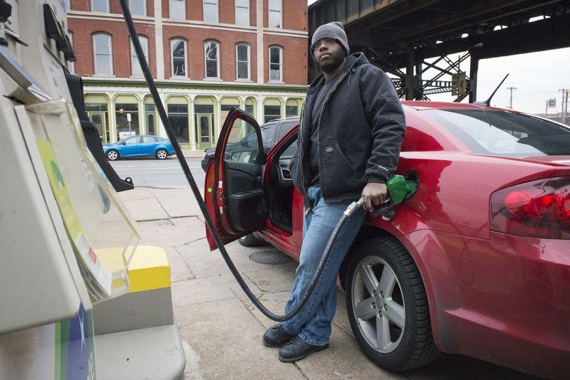 Man gets gasoline at a BP station in St. Louis, Missouri
