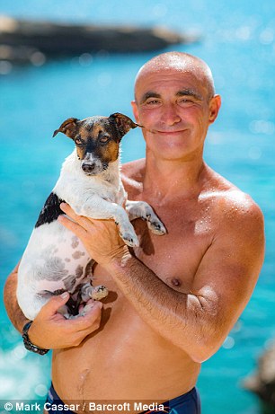 Mr Abelo holds his dog