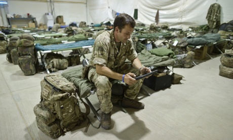 Staff Sergent Craig Worsley, 34, of 1st The Queen's Dragoon Guards, sitting inside temporary tented accommodation at Camp Bastion as troops prepare to withdraw and return to the UK.
