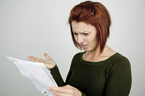 woman looking at credit card statement
