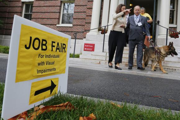 Richard O'Driscoll and his guide dog Maxwell leave the fourth Annual Job Fair for Individuals with Visual Impairments in Cambridge, Massachusetts October 16, 2014. REUTERS/Brian Snyder