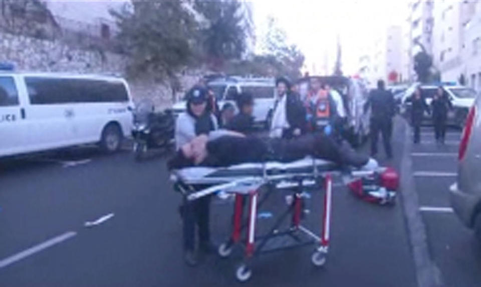 This frame grab from an APTN video shows the scene in Jersualem  where two Palestinians stormed a Jerusalem synagogue on Tuesday, Nov. 18, 2014...