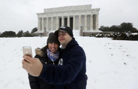 Couple takes a &quot;selfie&quot; at the snowy Lincoln Memorial  in Washington