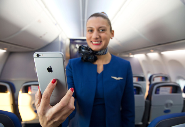 United attendant brandishing an iPhone 6 Plus