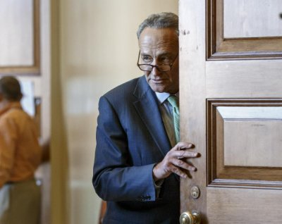 Sen. Chuck Schumer, D-N.Y., emerges from a Democratic caucus meeting at the Capitol in Washington, Tuesday, Nov. 18, 2014. (AP Photo/J. Scott Applewhite)