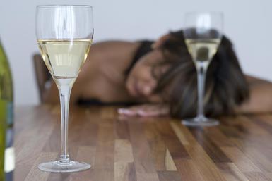 woman passed out on table with wine glasses - Eva Mueller/Stockbyte/Getty Images