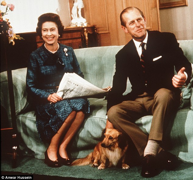 The Queen relaxes with Prince Philip with their Corgis while reading the newspapers at Balmoral in 1975