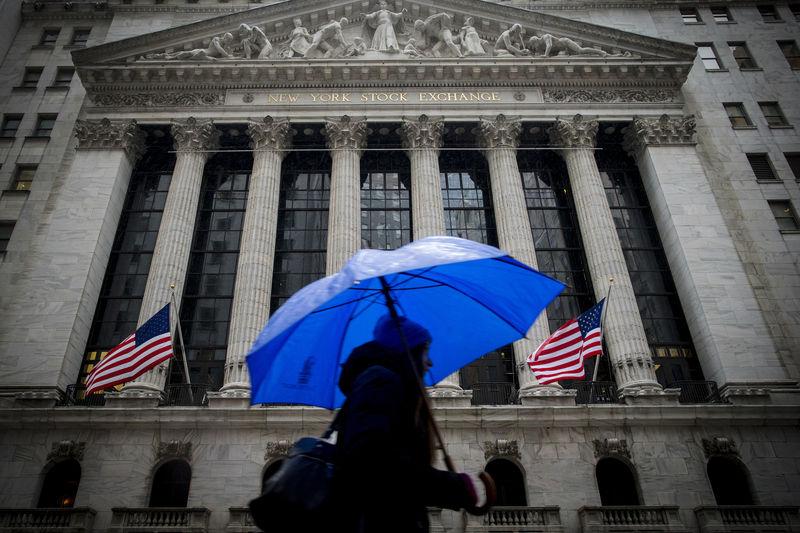 A morning commuter carries an umbrella as she passes by the NYSE during a winter storm in New York