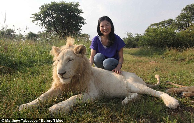 Japanese tourist Sachi Kamio poses with one of the endangered beasts