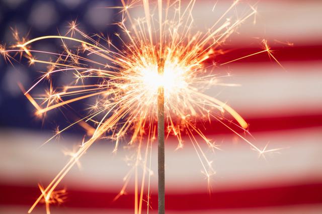 Photo of 4th of July Sparkler and Flag - photo © Getty / Tetra Images
