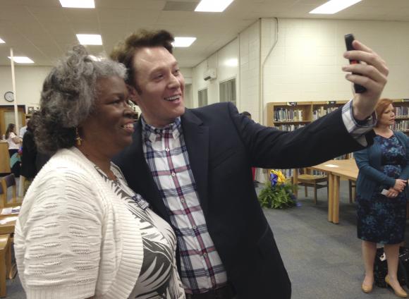 Democratic nominee Clay Aiken takes a pictures with a constituent after a campaign forum in Cary, North Carolina in this April 28, 2014 file photo. REUTERS/Colleen Jenkins/Files
