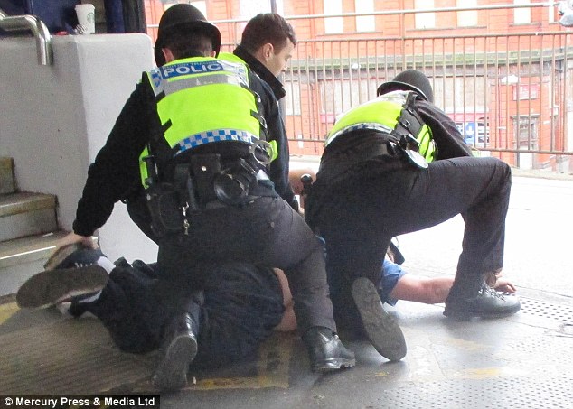 The 47-year-old man, from Leigh, Greater Manchester, was later restrained by police (pictured). He appeared yesterday at Salford Magistrates' Court and pleaded guilty to railway trespass