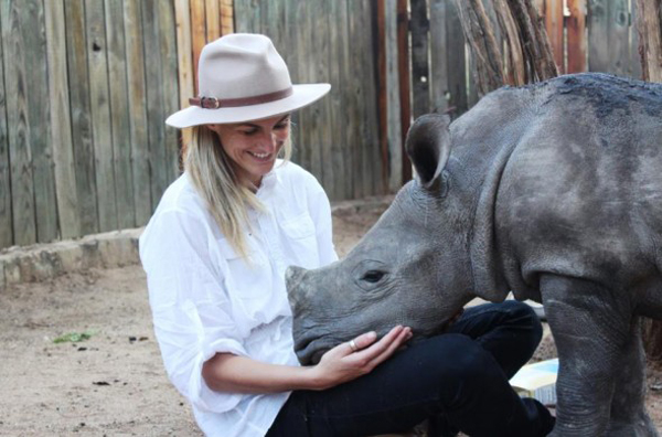 An orphaned baby rhino is rescued after poachers slaughter his mother