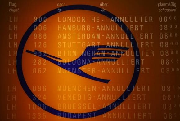 A picture taken with the multiple exposure function of the camera shows cancelled flights on a flight schedule board and the logo of German air carrier Lufthansa at the Fraport airport in Frankfurt April 2, 2014. REUTERS/Kai Pfaffenbach