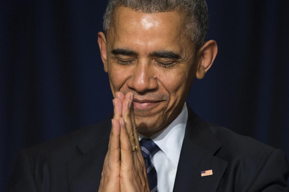 President Barack Obama bows his head toward the Dalai Lama as he was recognized during the National Prayer Breakfast in Washington, Thursday, Feb. 5, ...