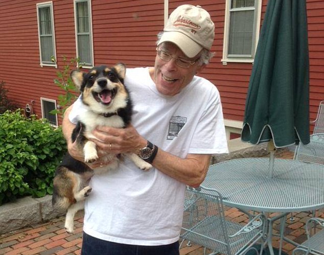 Legendary horror story writer holding his pet dog Molly, aka The Thing of Evil