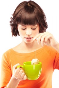 Young Woman Making a Cup of Green Tea