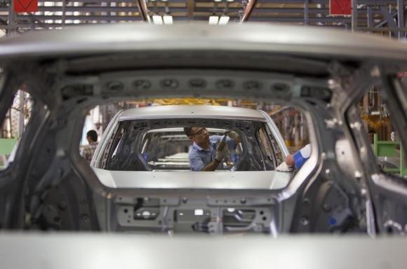 An employee works on an assembly line at the General Motors plant in Asaka August 29, 2012.  REUTERS/Shamil Zhumatov