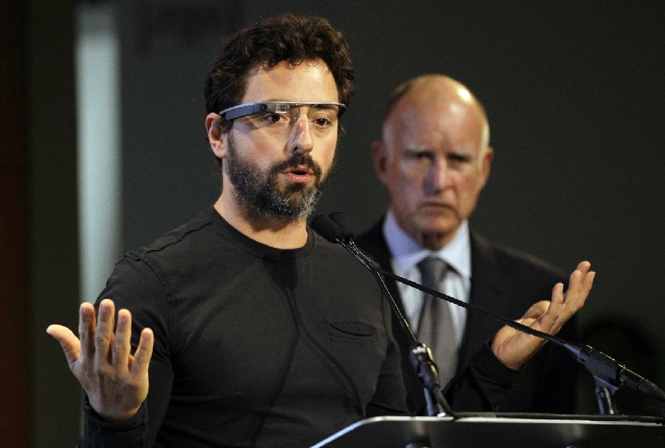 In this Sept. 25, 2012 file photo, Google co-founder Sergey Brin, left, wearing Google Glass, speaks as California Gov. Jerry Brown, right, listens...