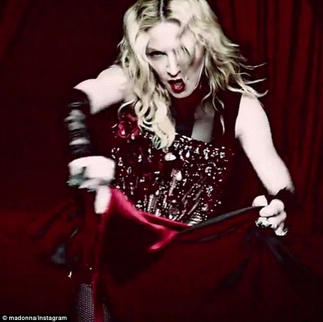 Toro! Madonna turns up the heat once again as she transforms into a lingerie clad bullfighter in her video Living For Love