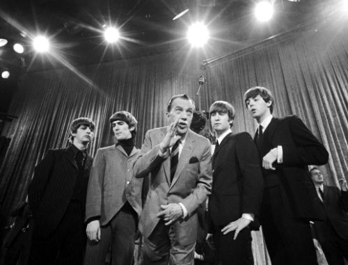 FILE - In this Feb. 8, 1964 file photo, Ed Sullivan, center, stands with The Beatles, from left, Ringo Starr, George Harrison, John Lennon and Paul McCartney, during a rehearsal for the British group's first American appearance on "The Ed Sullivan Show," in New York. While forever a Beatle in the hearts of millions - and McCartney still instinctively refers to "we" when telling old stories - he keeps his mind open to all moments. He tries his best to update his accounts on Facebook and Twitter, although the fine points of Spotify and other streaming services are beyond him (that's what lawyers are for). (AP Photo, File)