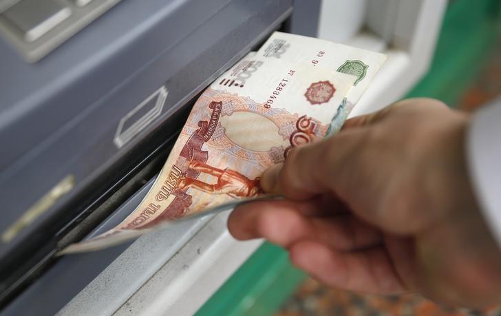 Man uses a cash dispenser to receive roubles in central Moscow
