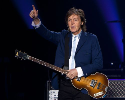 FILE - In this Oct. 15, 2014 file photo, former Beatle Sir Paul McCartney performs in concert as part of his Out There tour at Philips Arena in Atlanta. McCartney is 72, and only the wrinkles give his years away. Interviewed recently at his midtown Manhattan office suite, he seems as boyish and graceful as he was on stage decades ago for "The Ed Sullivan Show," his manner informal, his build slender and well suited for jeans and a form-fitting sweater. (Photo by Dan Harr/Invision/AP, File)