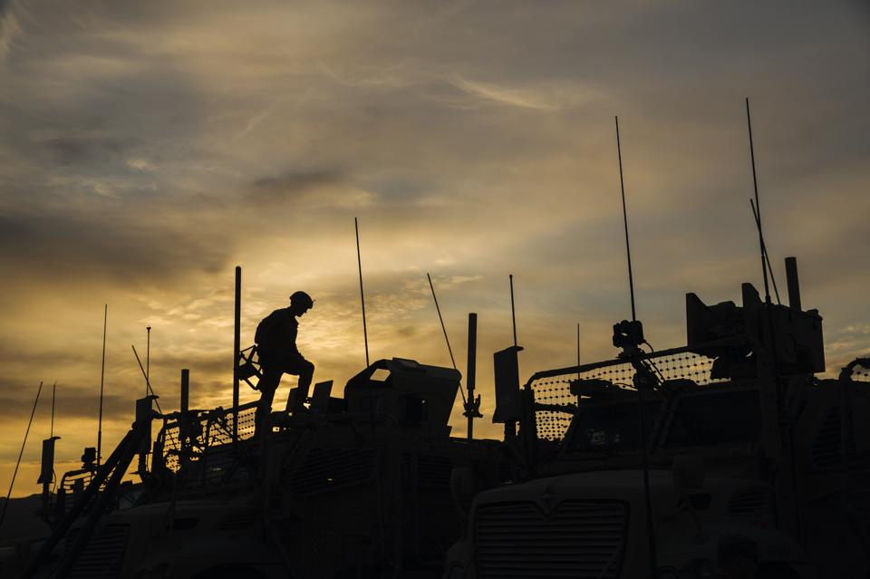 A U.S. soldier from the 3rd Cavalry Regiment prepares his MRAP vehicle for a mission on forward operating base Gamberi in the Laghman province of...
