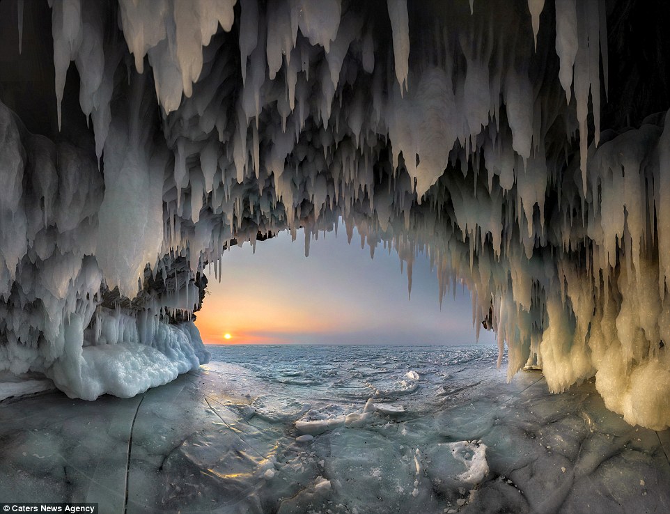 Russian photographer Andrey Grachev risked his life on the frozen lake to capture breathtaking images of the ice cave at sunrise