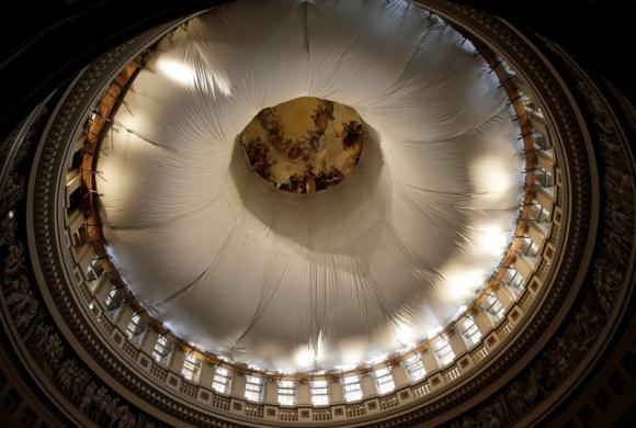 Sunlight streams into the interior of the U.S. Capitol dome, covered in tarps for repairs, and is seen from the Rotunda in Washington November 6, 2014. REUTERS/Gary Cameron