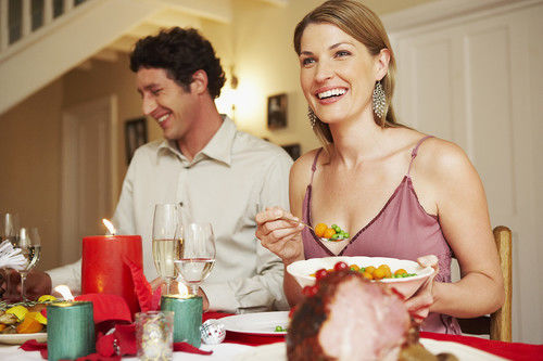 husband and wife at holiday dinner table